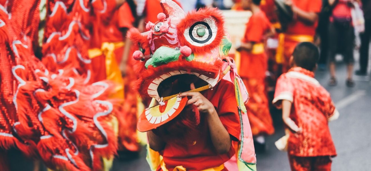 Lion dance during Chinese New Year celebration. Group of people perform a traditional lion dance.
